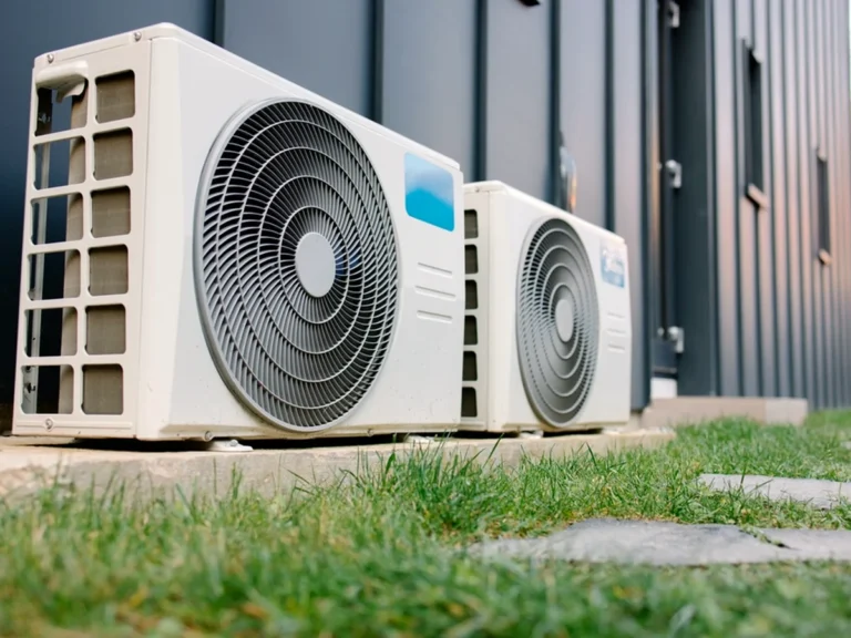 Oceanview technician servicing residential air conditioner condensers