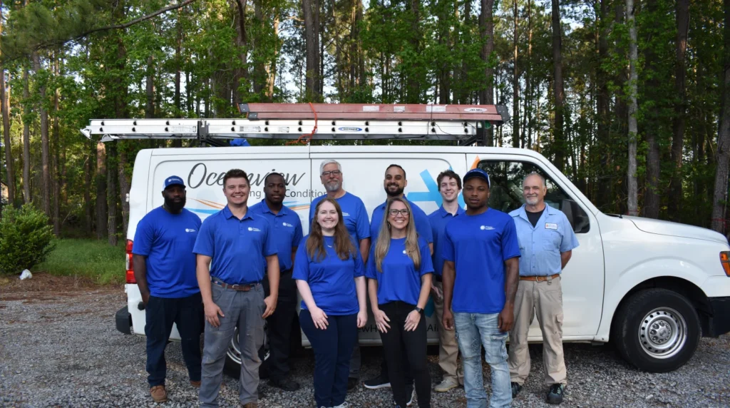 The Oceanview Heating and Air team in front of a service van